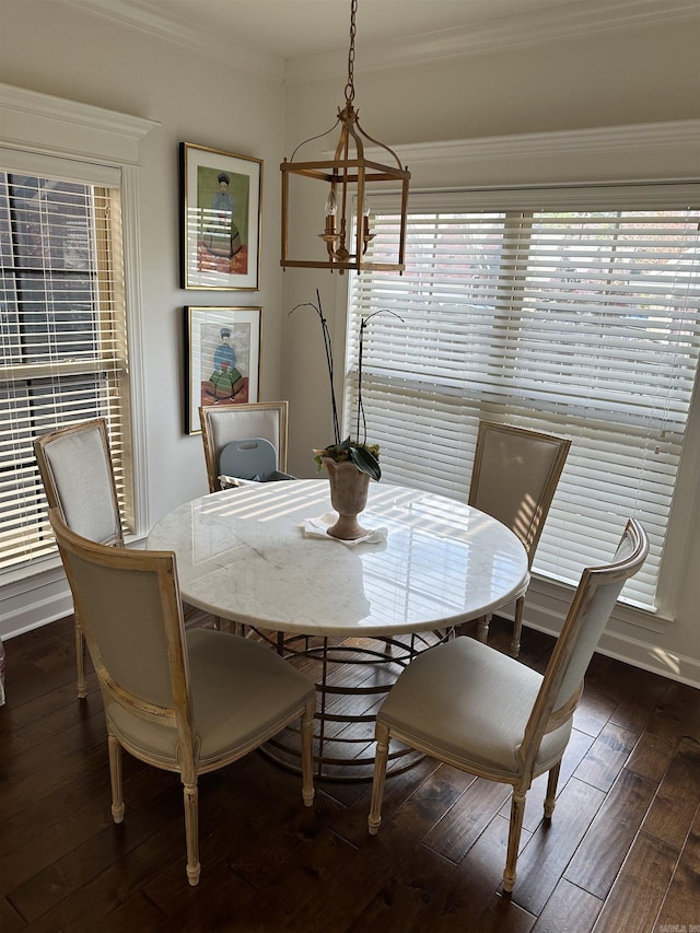 dining space featuring ornamental molding, dark hardwood / wood-style floors, and a notable chandelier