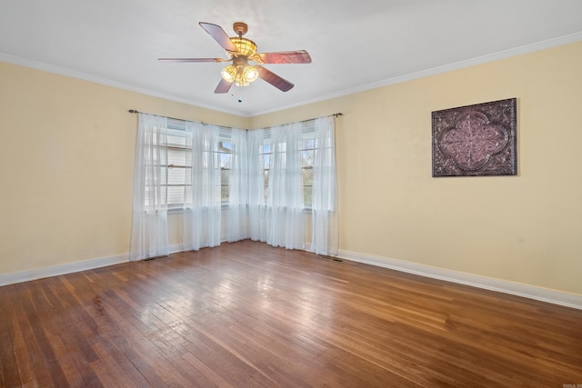 empty room with ceiling fan, hardwood / wood-style floors, and ornamental molding