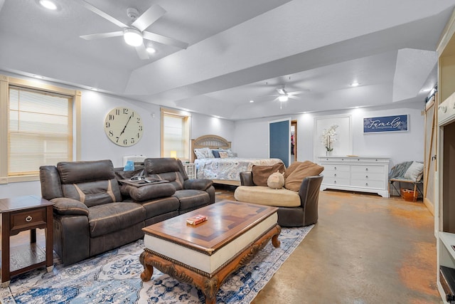 bedroom featuring concrete flooring, a tray ceiling, and ceiling fan