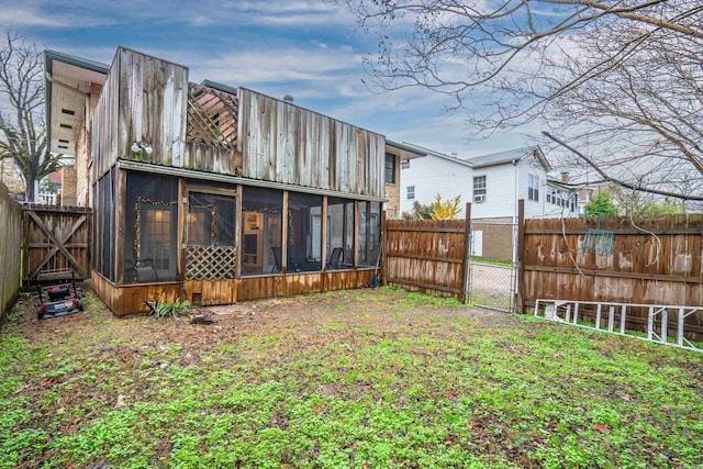 back of house featuring a sunroom