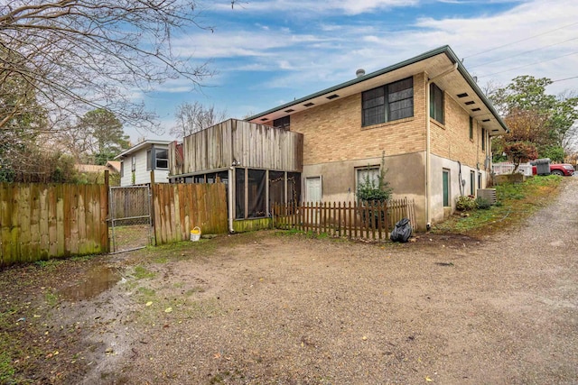 rear view of property featuring a sunroom