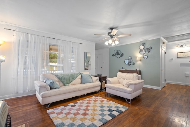 living room featuring heating unit, crown molding, ceiling fan, and dark wood-type flooring