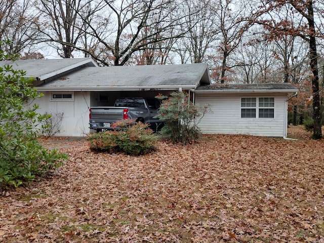 back of property with a carport