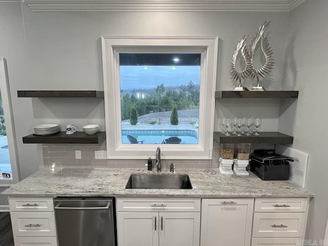 kitchen with white cabinetry, sink, dishwasher, and light stone countertops