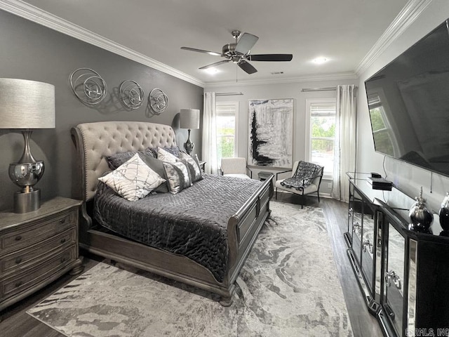 bedroom with hardwood / wood-style floors, ceiling fan, and crown molding