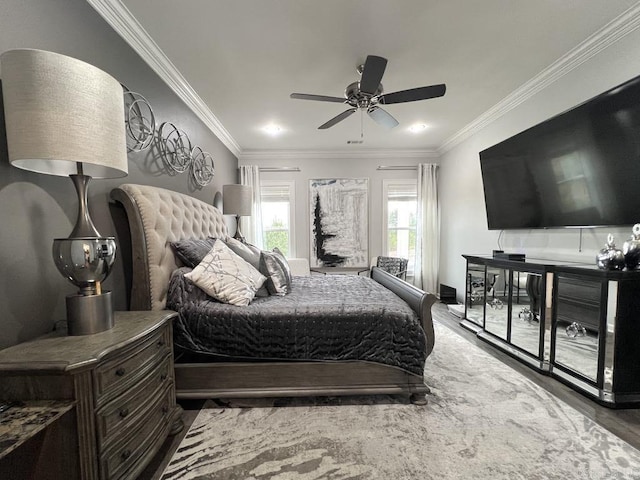 bedroom featuring ceiling fan, wood-type flooring, and crown molding