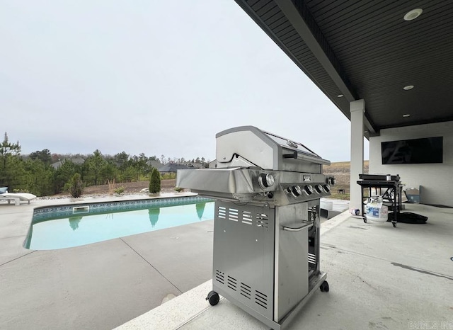 view of pool with a patio area and grilling area