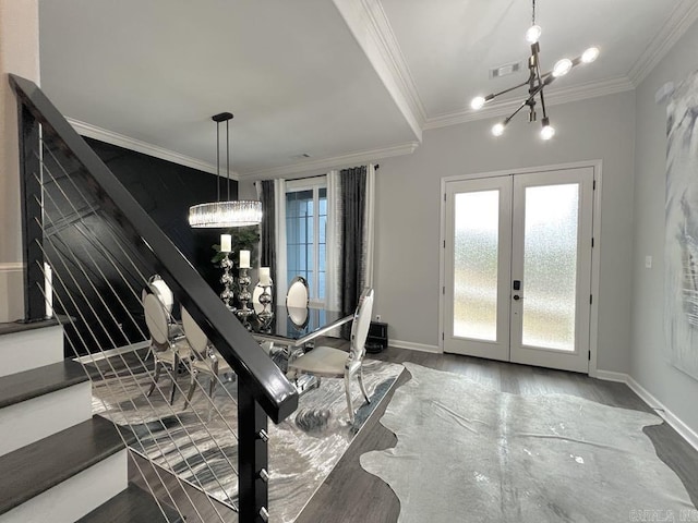 entrance foyer featuring crown molding, dark hardwood / wood-style floors, and an inviting chandelier