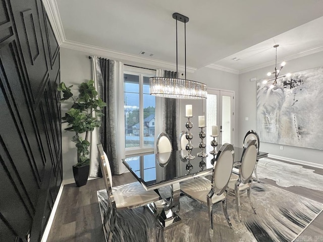 dining room featuring dark wood-type flooring, a notable chandelier, and ornamental molding