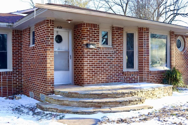 property entrance with brick siding