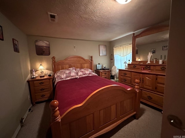 carpeted bedroom featuring a textured ceiling