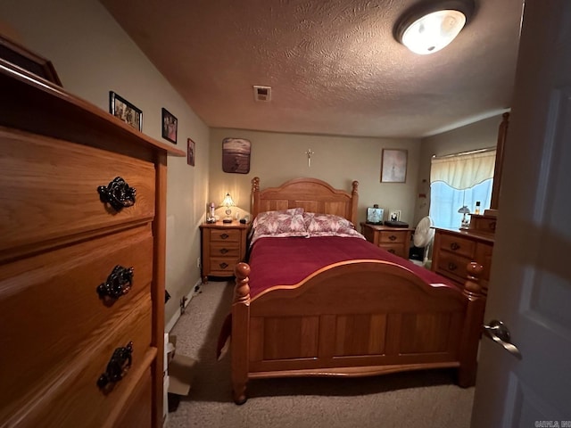 carpeted bedroom featuring a textured ceiling