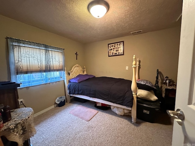 carpeted bedroom featuring a textured ceiling