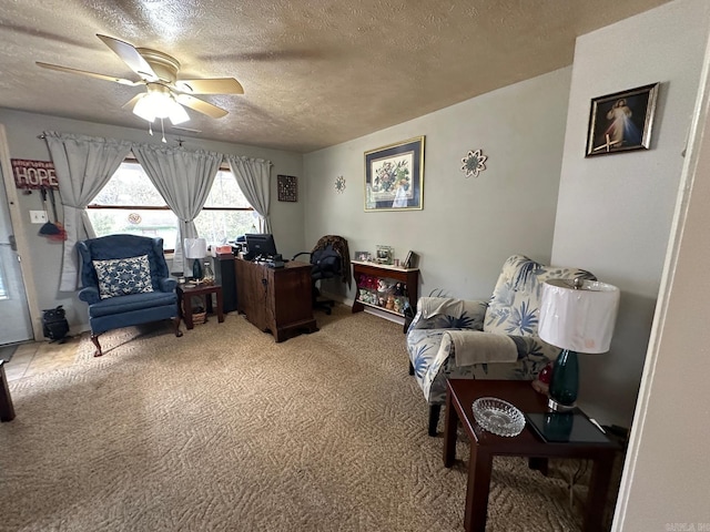 carpeted home office featuring ceiling fan and a textured ceiling