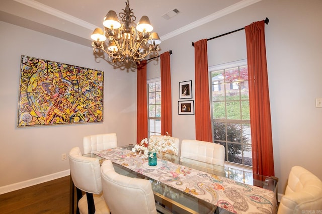 dining area with ornamental molding, dark wood-type flooring, and an inviting chandelier