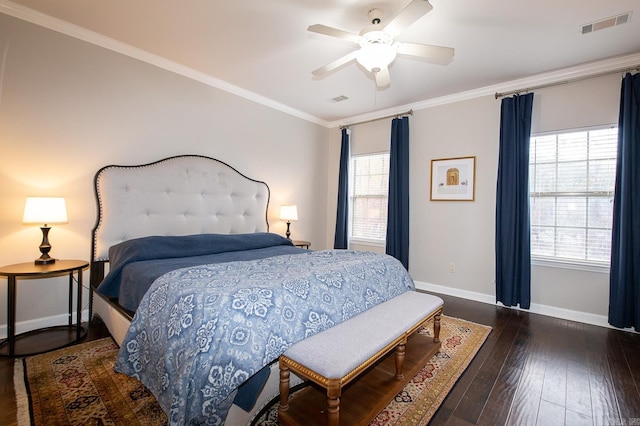 bedroom featuring dark hardwood / wood-style flooring, multiple windows, crown molding, and ceiling fan