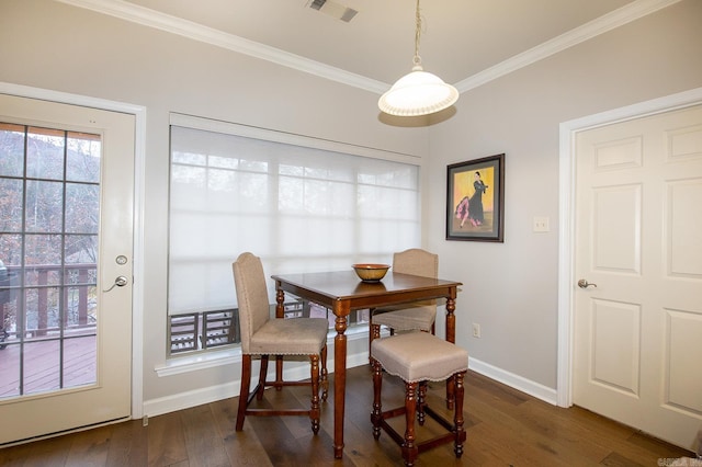 dining area with dark wood-type flooring and ornamental molding