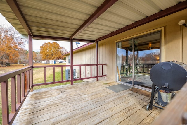 wooden deck with a yard and central AC