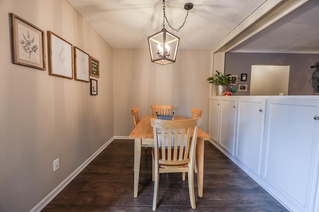 dining area with a textured ceiling, an inviting chandelier, and dark wood-type flooring