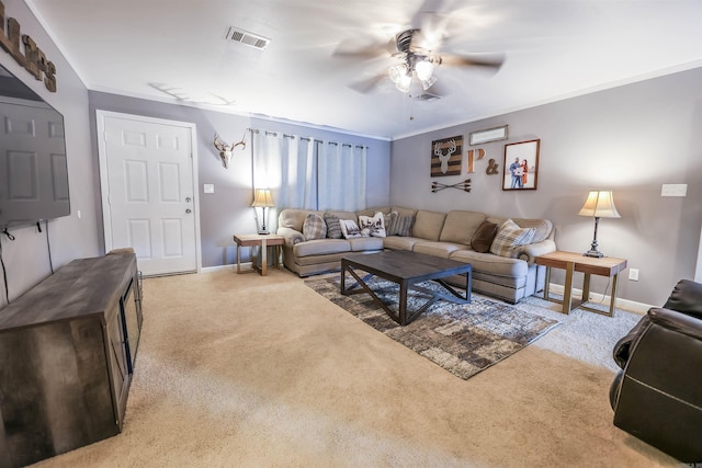 living room featuring ceiling fan, ornamental molding, and light carpet