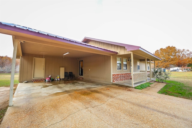 exterior space with a carport and covered porch