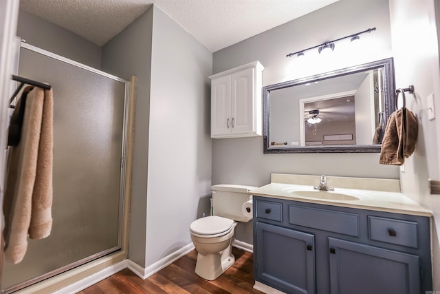 bathroom featuring hardwood / wood-style floors, a shower with shower door, and a textured ceiling