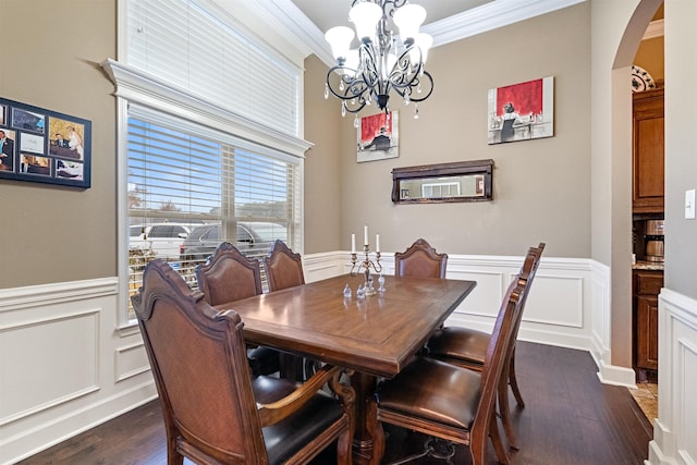 dining room with a notable chandelier, dark hardwood / wood-style flooring, and ornamental molding