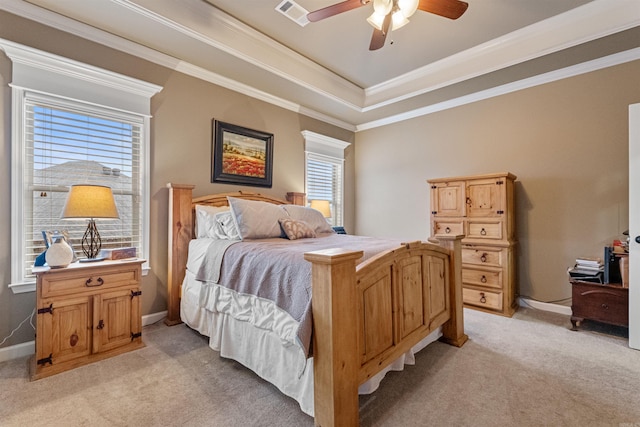 carpeted bedroom featuring a raised ceiling, ceiling fan, and ornamental molding