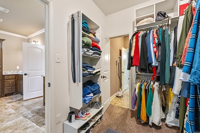 spacious closet with light tile patterned floors