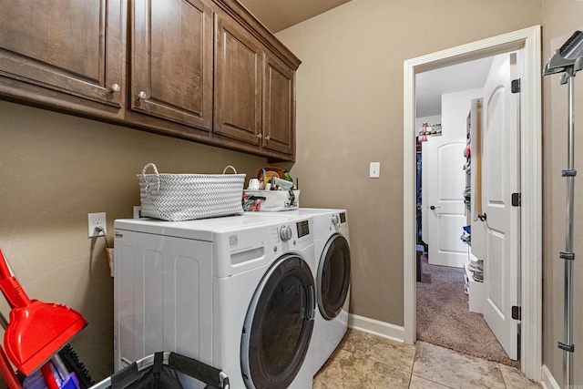 washroom featuring cabinets, independent washer and dryer, and light tile patterned floors