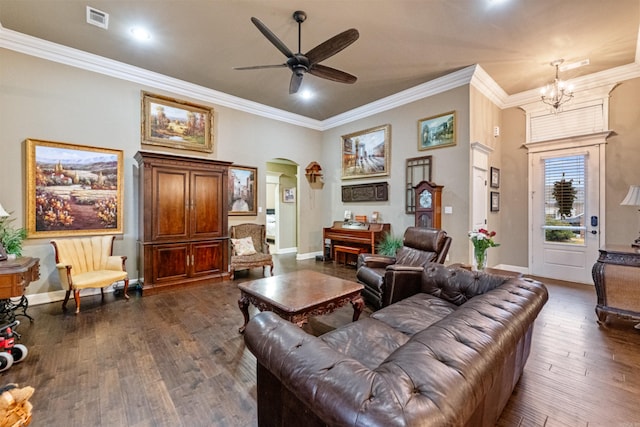 living room featuring crown molding, dark wood-type flooring, and ceiling fan with notable chandelier