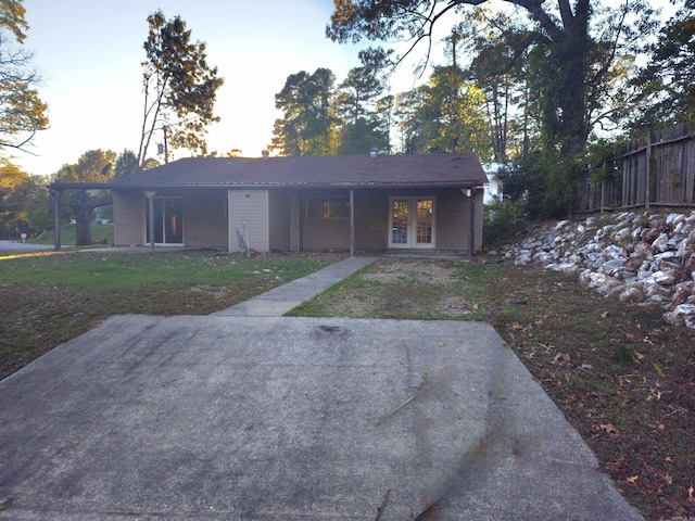 rear view of property featuring a lawn