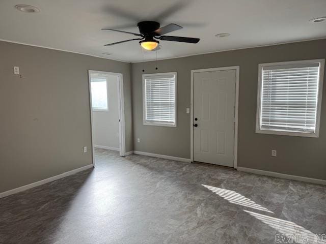 unfurnished room with ceiling fan