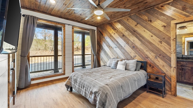 bedroom with wood walls, light hardwood / wood-style floors, access to exterior, and wood ceiling