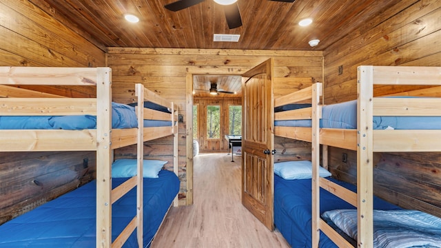 bedroom featuring wood-type flooring, french doors, wooden walls, and wood ceiling