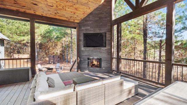 unfurnished sunroom featuring wooden ceiling, a fireplace, and vaulted ceiling