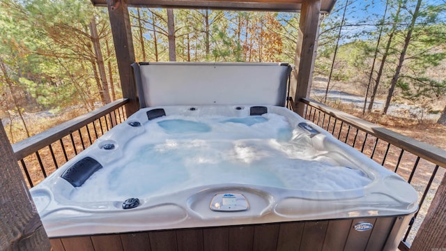 wooden deck with a hot tub