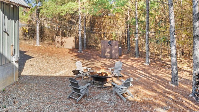 view of yard with an outdoor fire pit