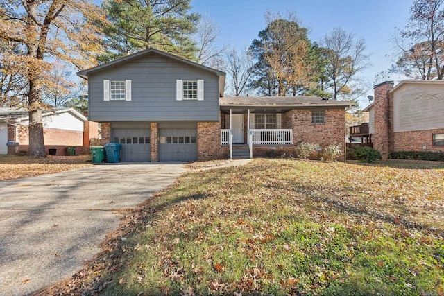 tri-level home with a porch and a garage