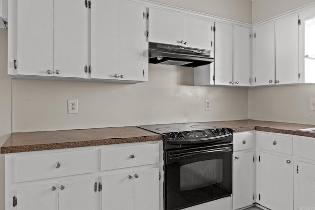 kitchen featuring white cabinetry and electric range