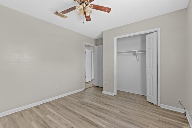 unfurnished bedroom with a closet, light hardwood / wood-style flooring, and ceiling fan