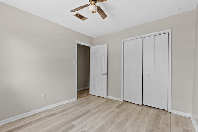 unfurnished bedroom featuring a closet, light hardwood / wood-style floors, and ceiling fan