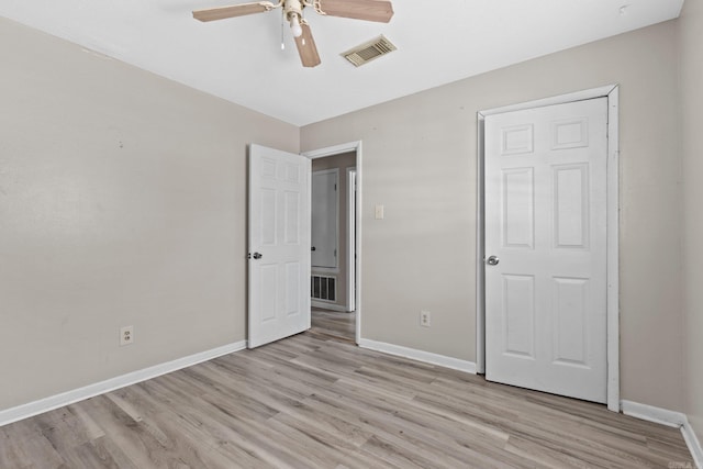 unfurnished bedroom featuring light wood-type flooring and ceiling fan