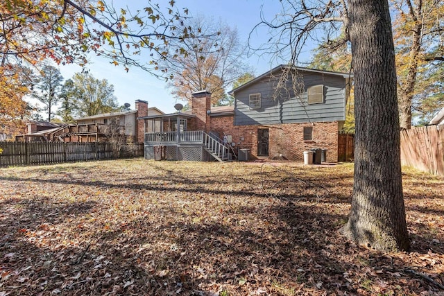 view of yard featuring a wooden deck and central AC