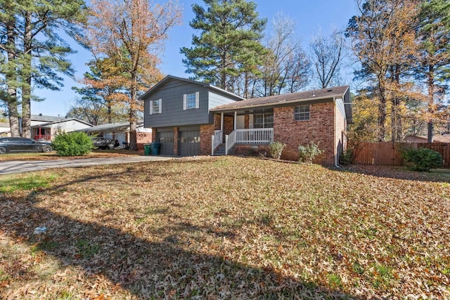 tri-level home with covered porch and a garage