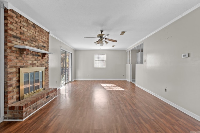 unfurnished living room featuring a fireplace, dark hardwood / wood-style flooring, ceiling fan, and ornamental molding