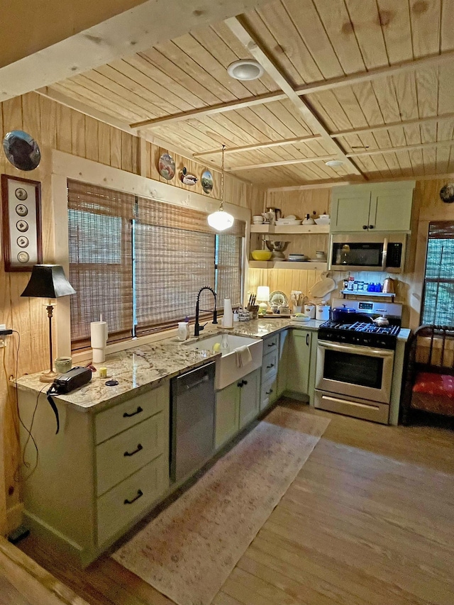 kitchen with dishwasher, gas range oven, and green cabinetry