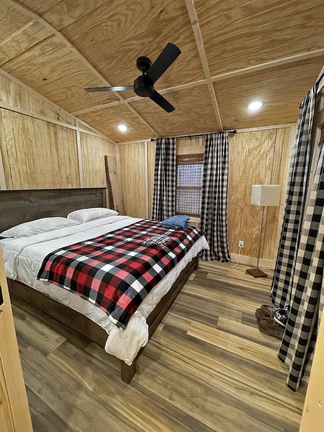 bedroom featuring hardwood / wood-style floors, ceiling fan, wooden ceiling, and wood walls