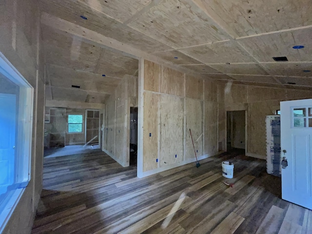 interior space with dark wood-type flooring and vaulted ceiling