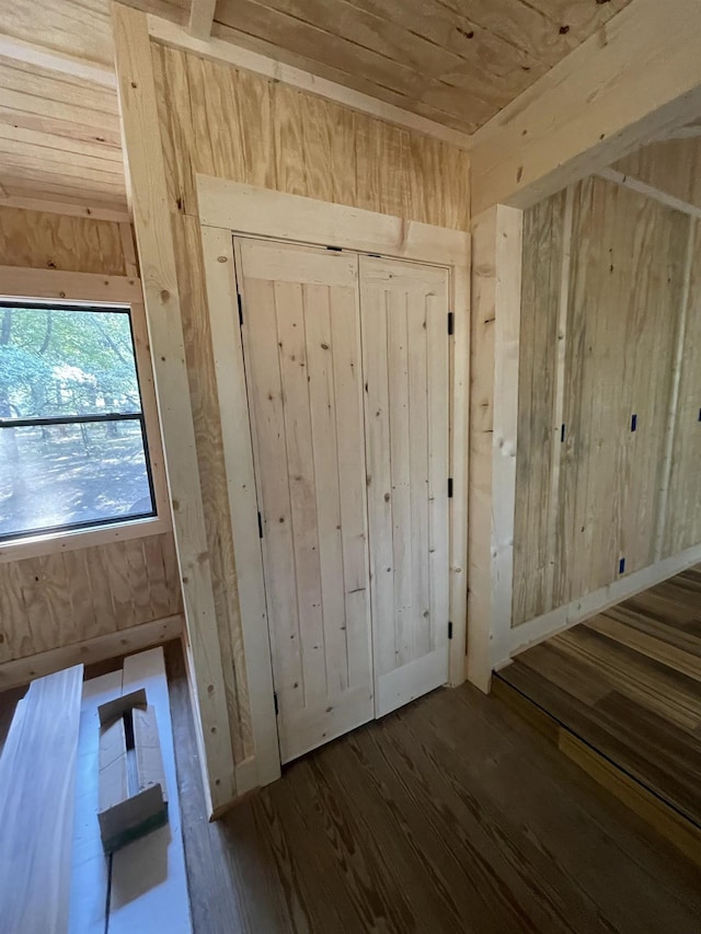 entryway with dark hardwood / wood-style flooring and wooden ceiling